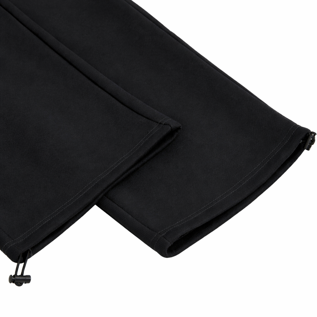 Black pants with a adjustable cuff on a white background
