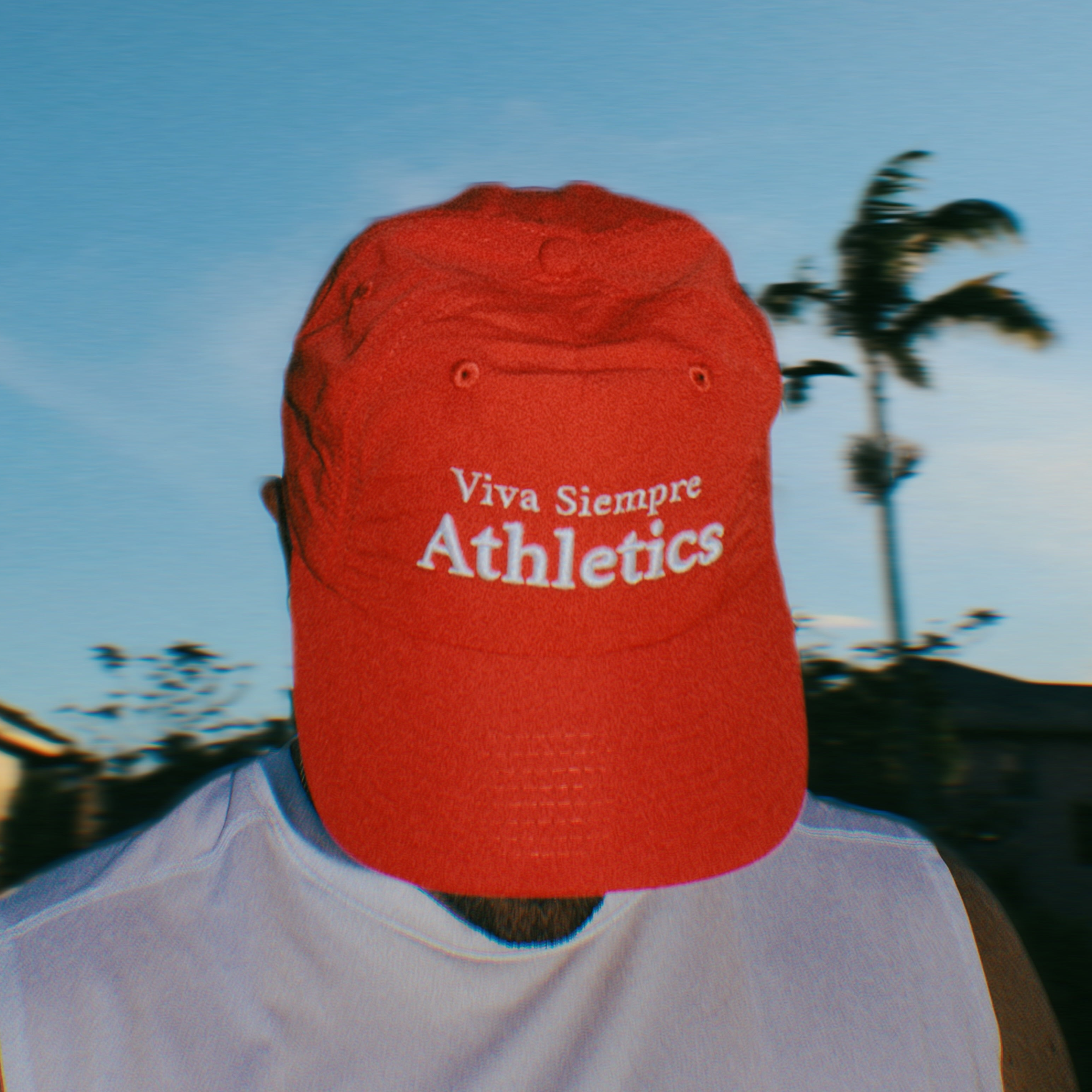 Runner wearing Viva Siempre Restart Hat Sunset Red